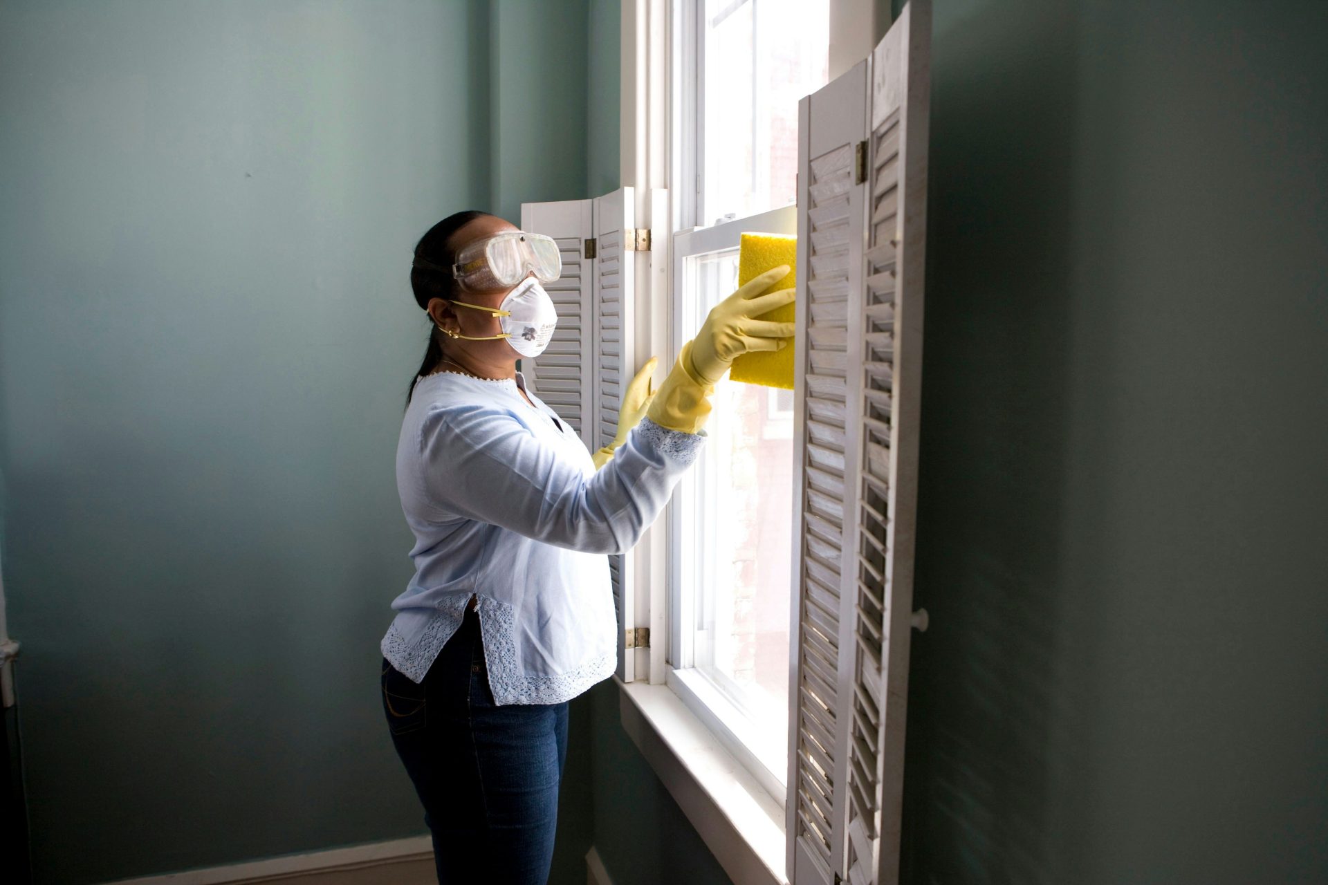 Technician cleaning window shutters